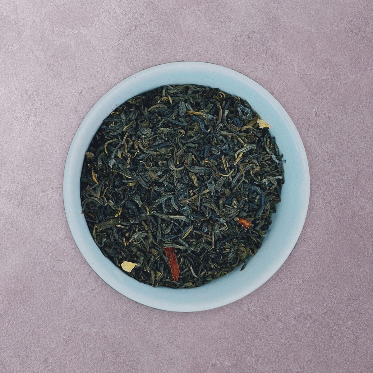 Wolf Ember Coffee Jasmine loose-leaf green tea in an artisan stoneware bowl